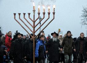 Lighting menorah candle in Odesa